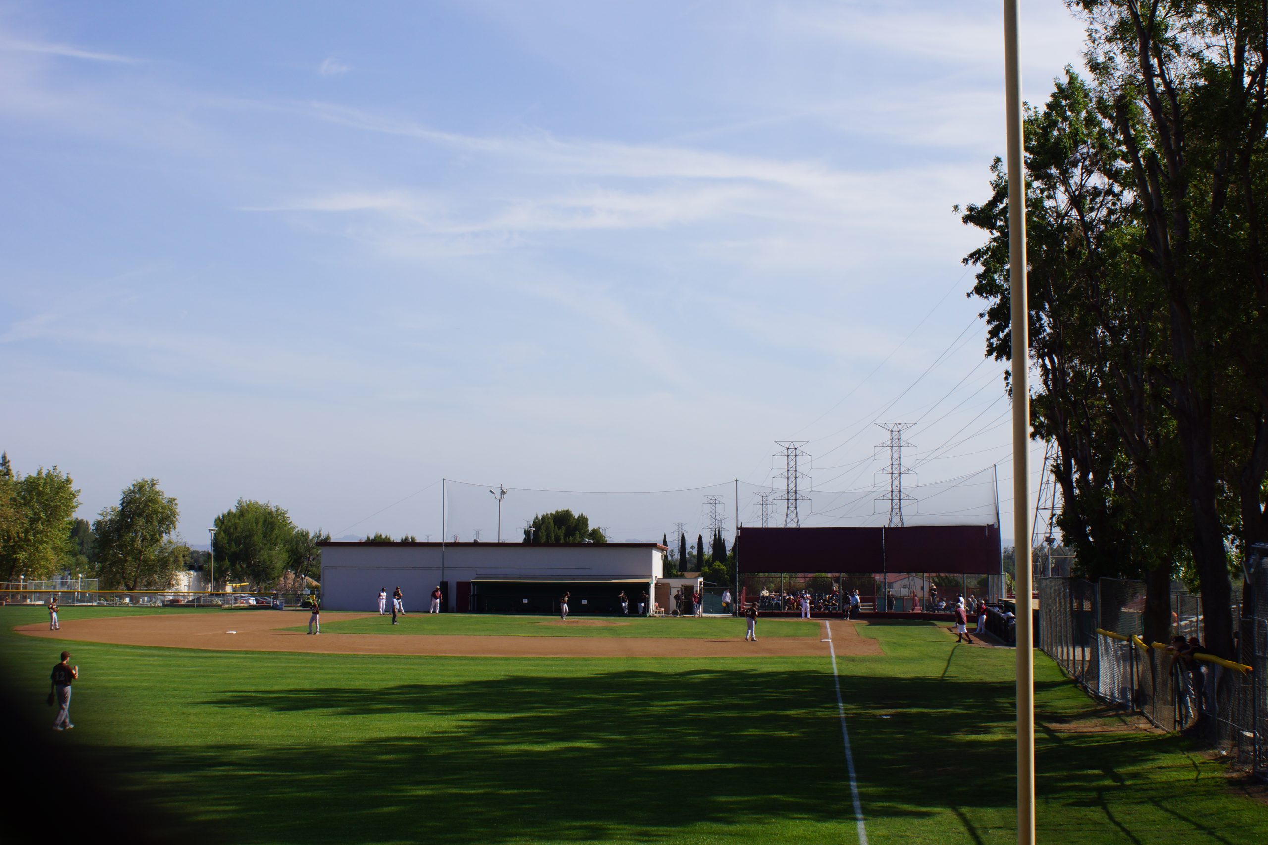 High school softball players competing on a field.