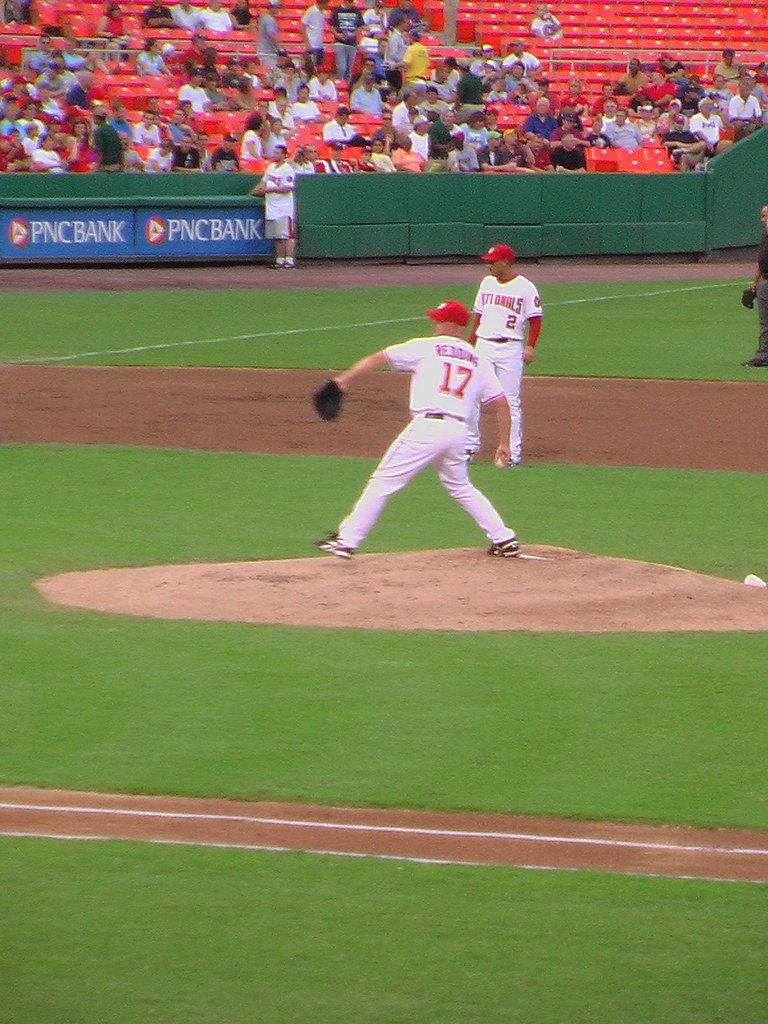 A baseball pitcher in the middle of a throw during a game.