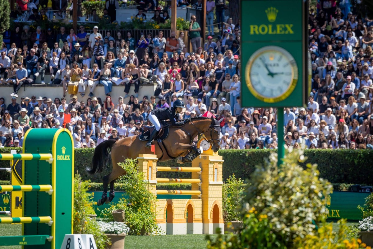 Riders and horses compete in a show jumping event at the historic Piazza di Siena in Rome.