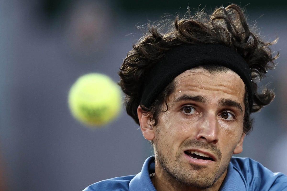 Tennis player Pierre-Hugues Herbert gestures during a dispute with a chair umpire at the French Open