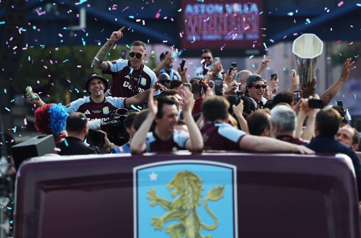 Aston Villa players and fans celebrating a trophy win during a city parade.