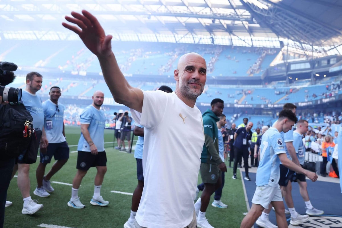 Pep Guardiola celebrates with Manchester City players after winning a trophy.