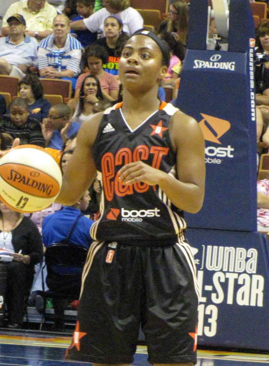 WNBA players in action during a basketball game.