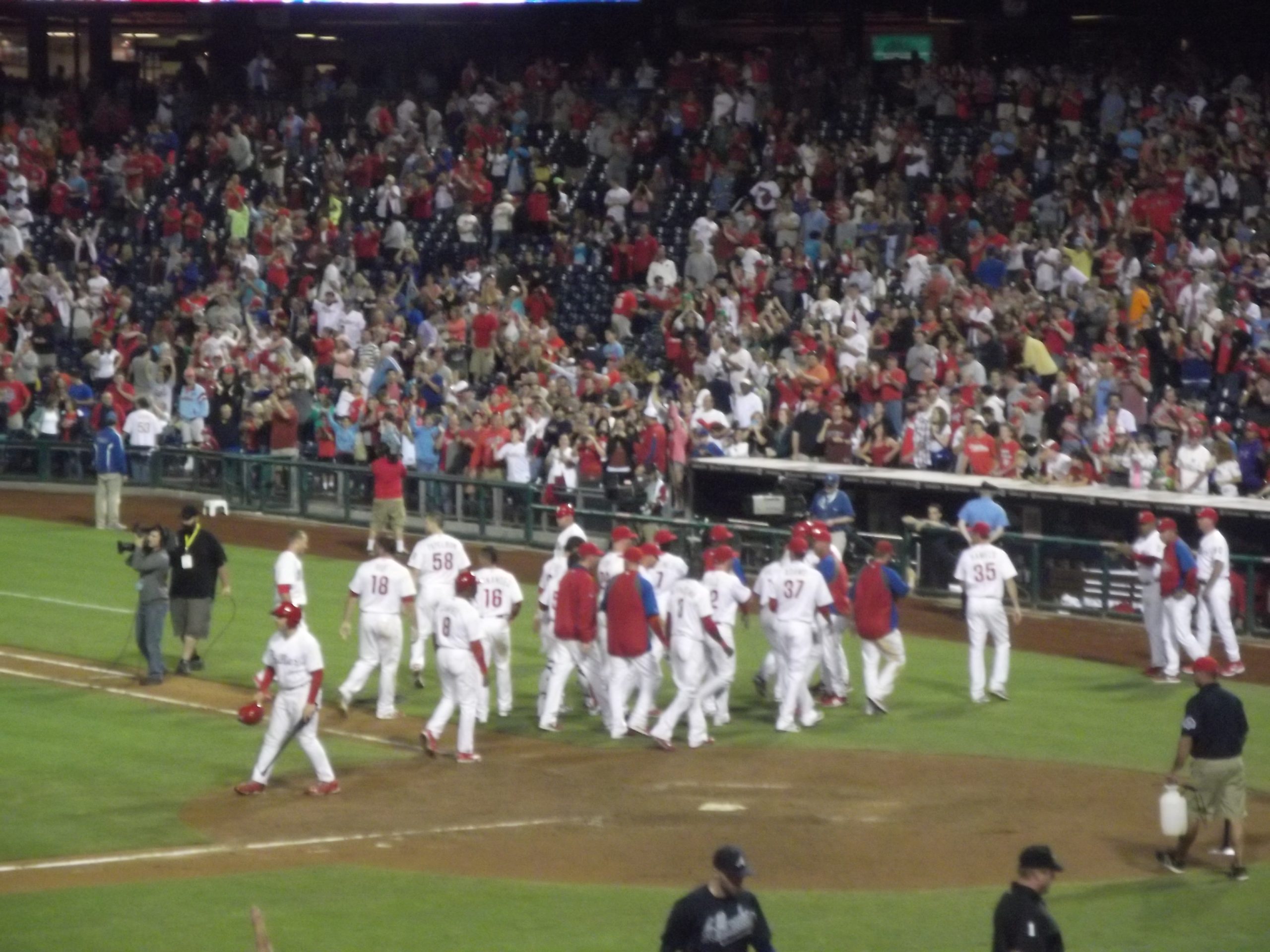 A Philadelphia Phillies player rounds the bases after hitting a home run.