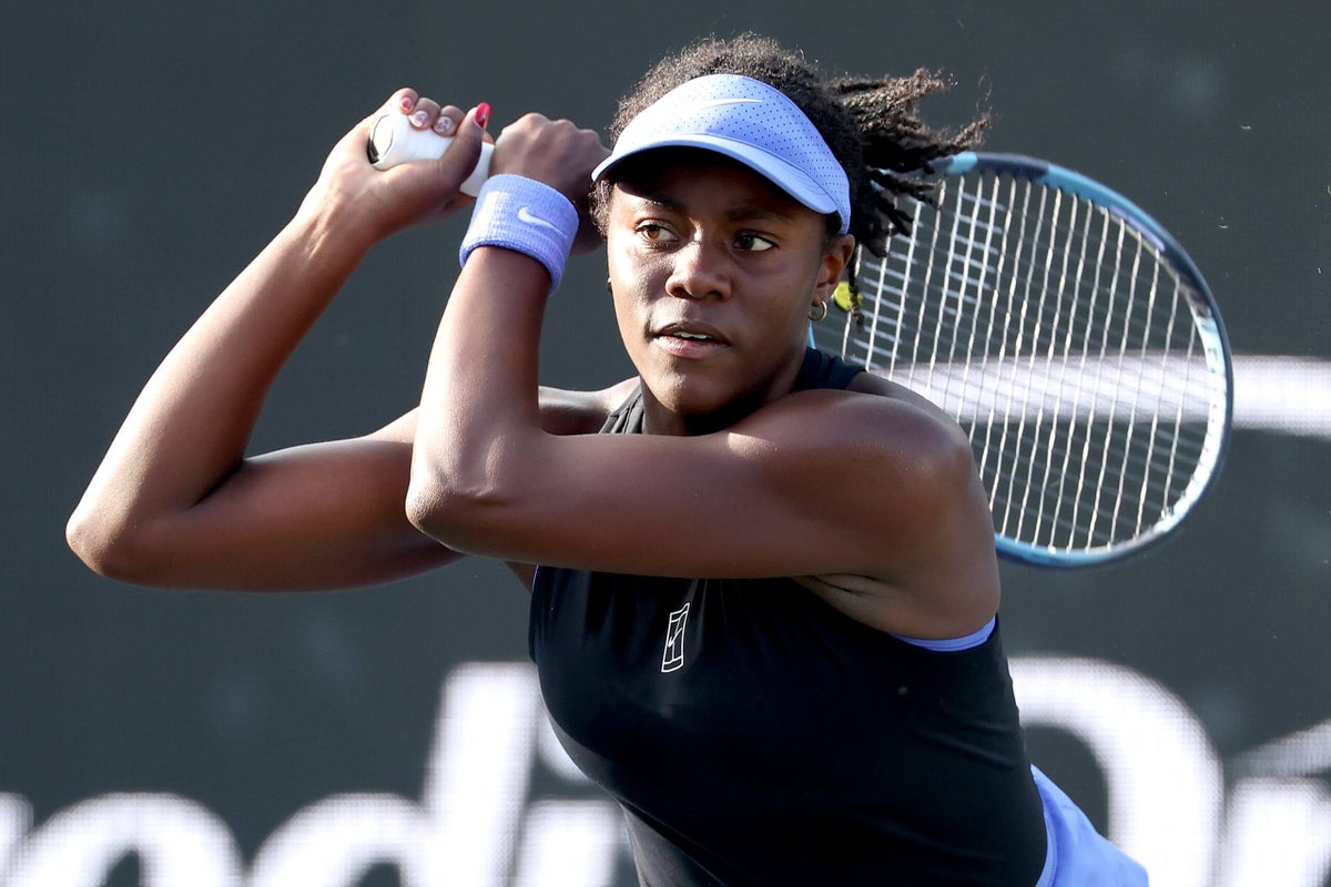 Akasha Urhobo in action on a clay court, hitting a forehand.