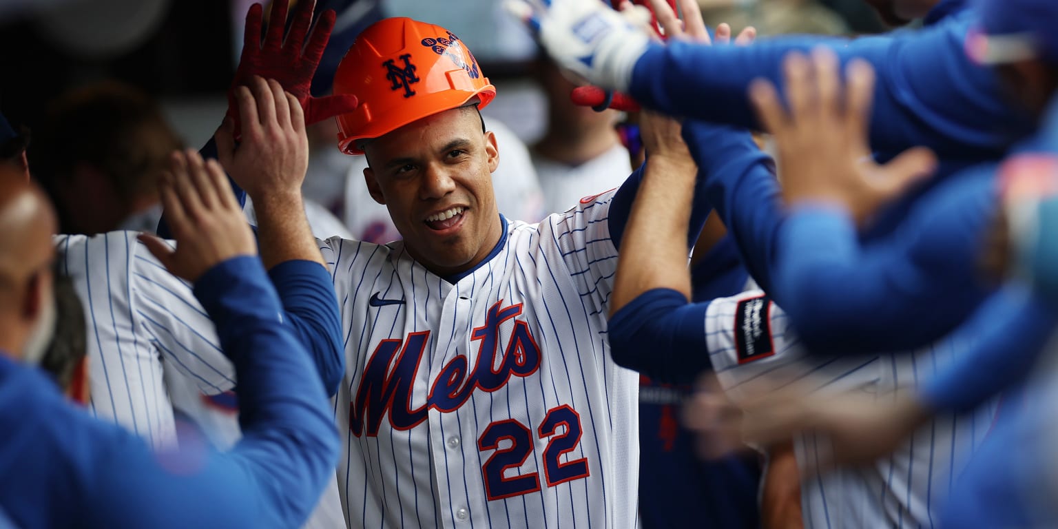 New York Mets players celebrating on the field at Citi Field after a sweep victory against the Detroit Tigers.