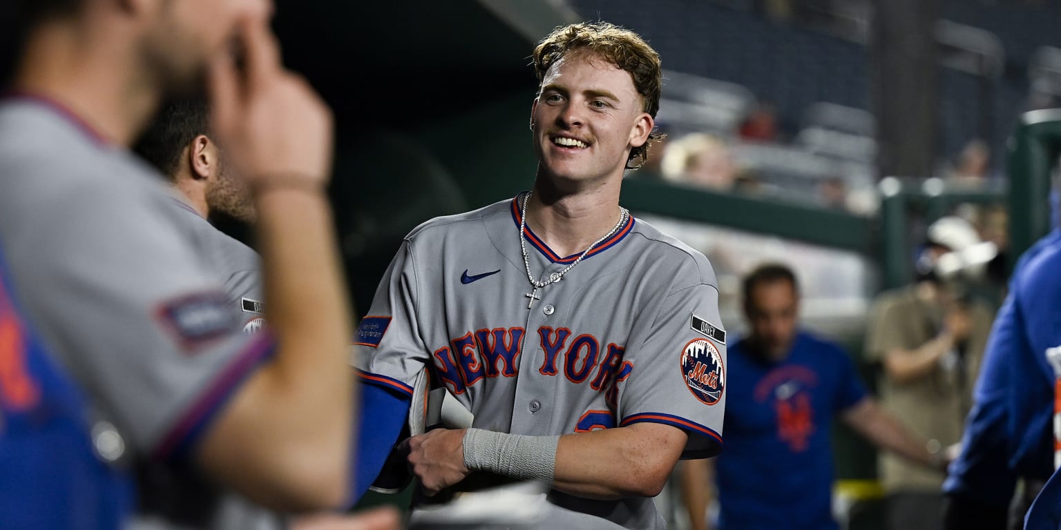 New York Mets players celebrating in the dugout after scoring 10 runs in the 12th inning against the Washington Nationals.