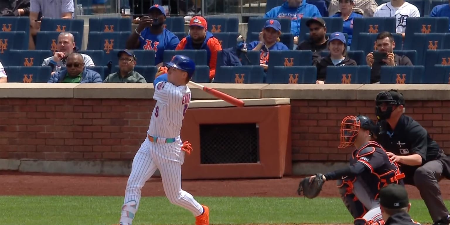 New York Mets player A.J. Ewing watching his first career home run sail over the outfield wall