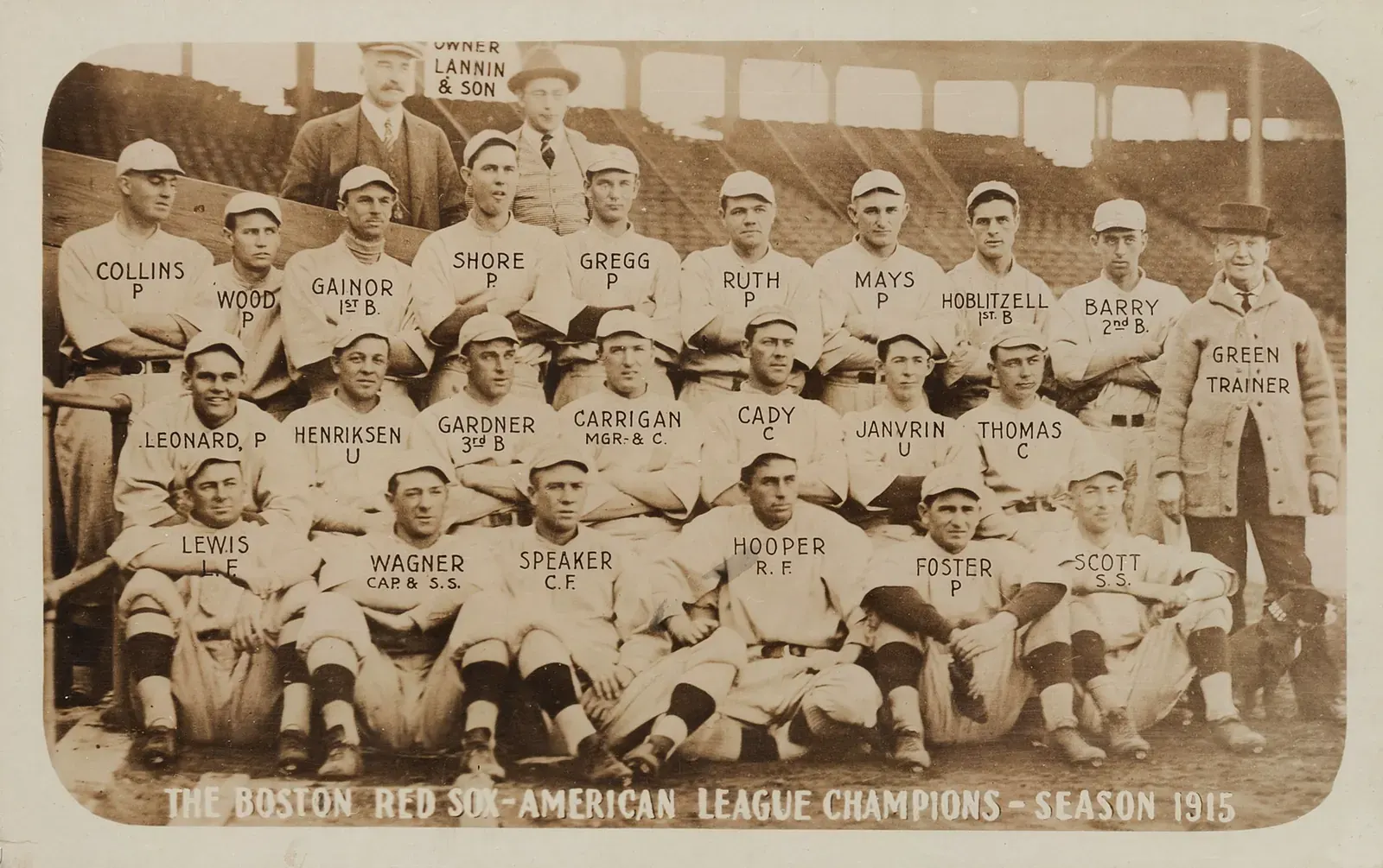 A baseball player in a Boston Red Sox uniform stands on a baseball field.