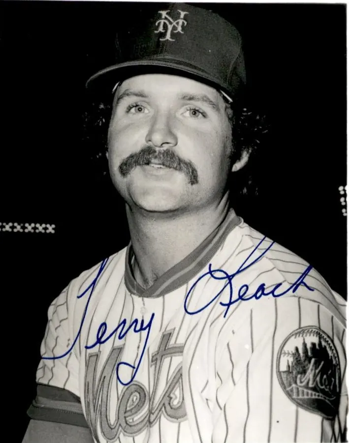 A baseball player in a New York Mets uniform on the field.