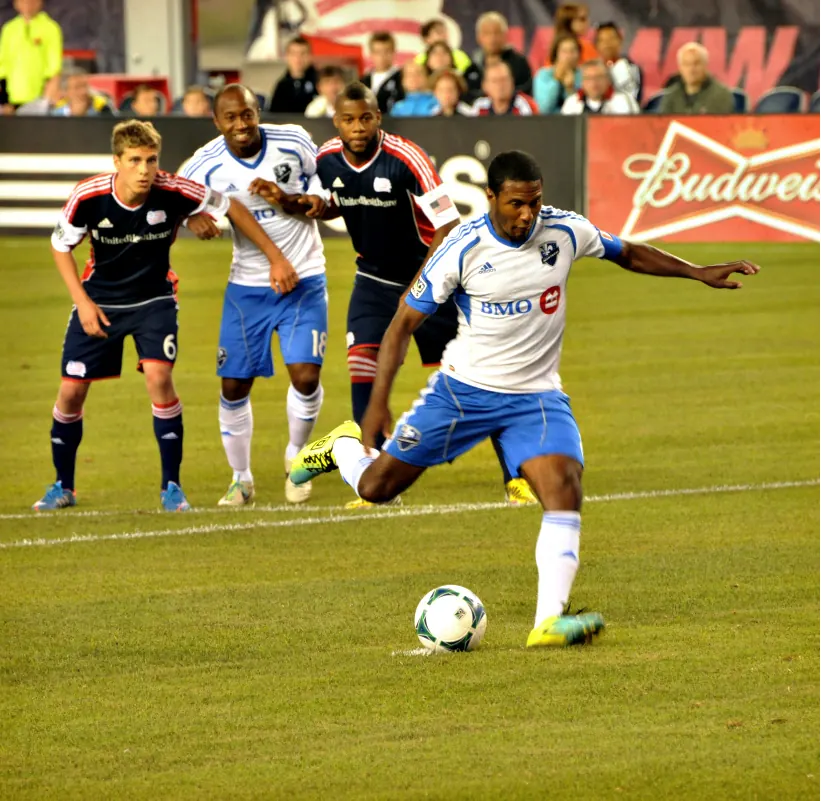 A football player in an NFL game looking towards the line of scrimmage.