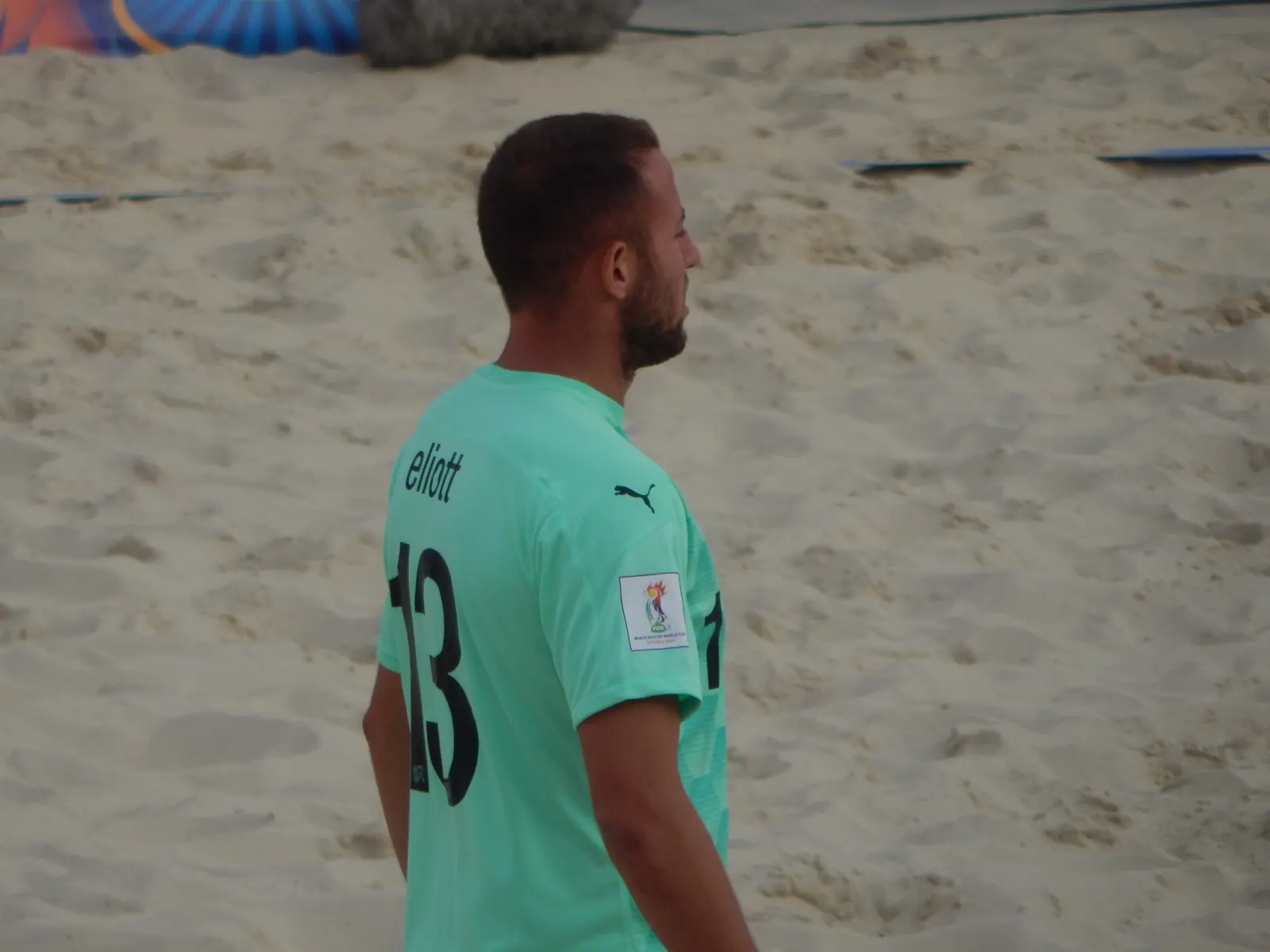 A soccer referee shows a red card to a player on the field during a World Cup match.
