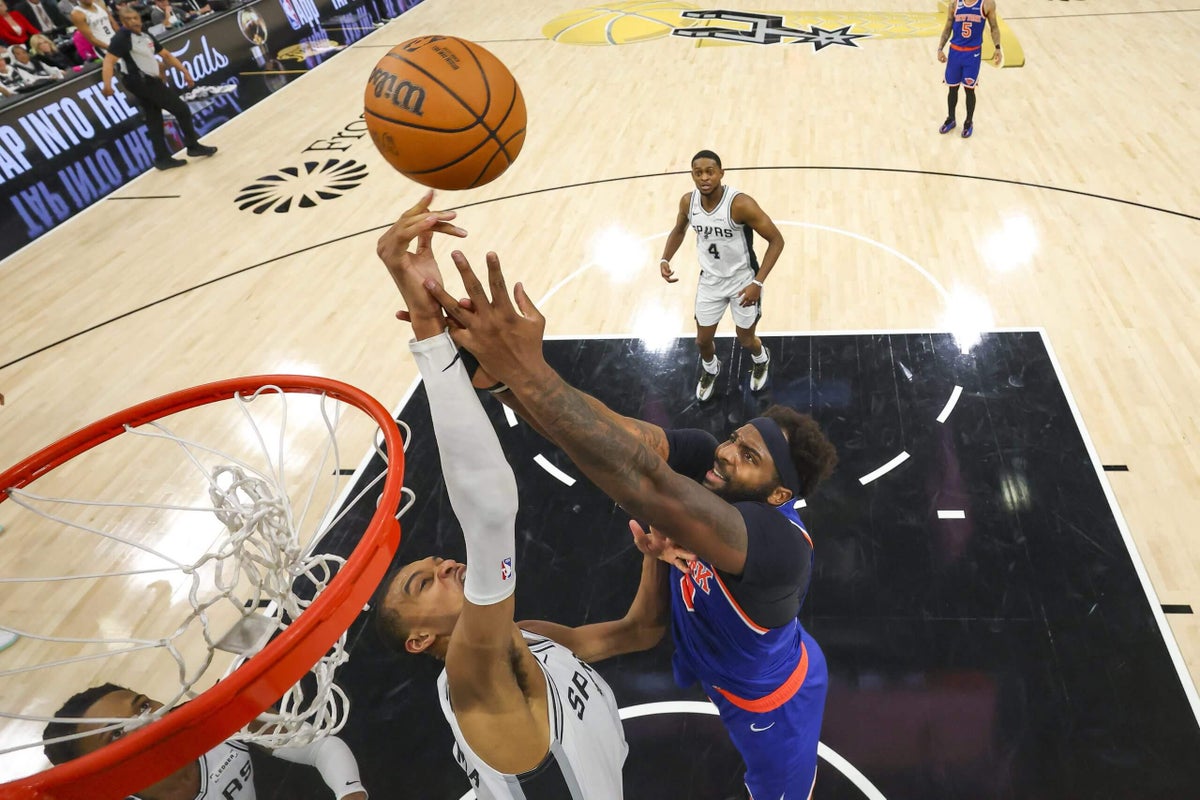 NBA player Mitchell Robinson in defensive stance against Victor Wembanyama