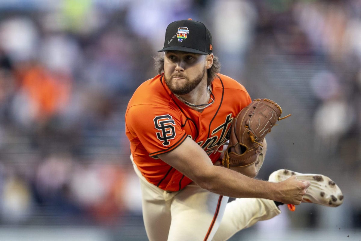 Three San Francisco Giants pitchers' hats with Bible verses inscribed on them during Pride Night.
