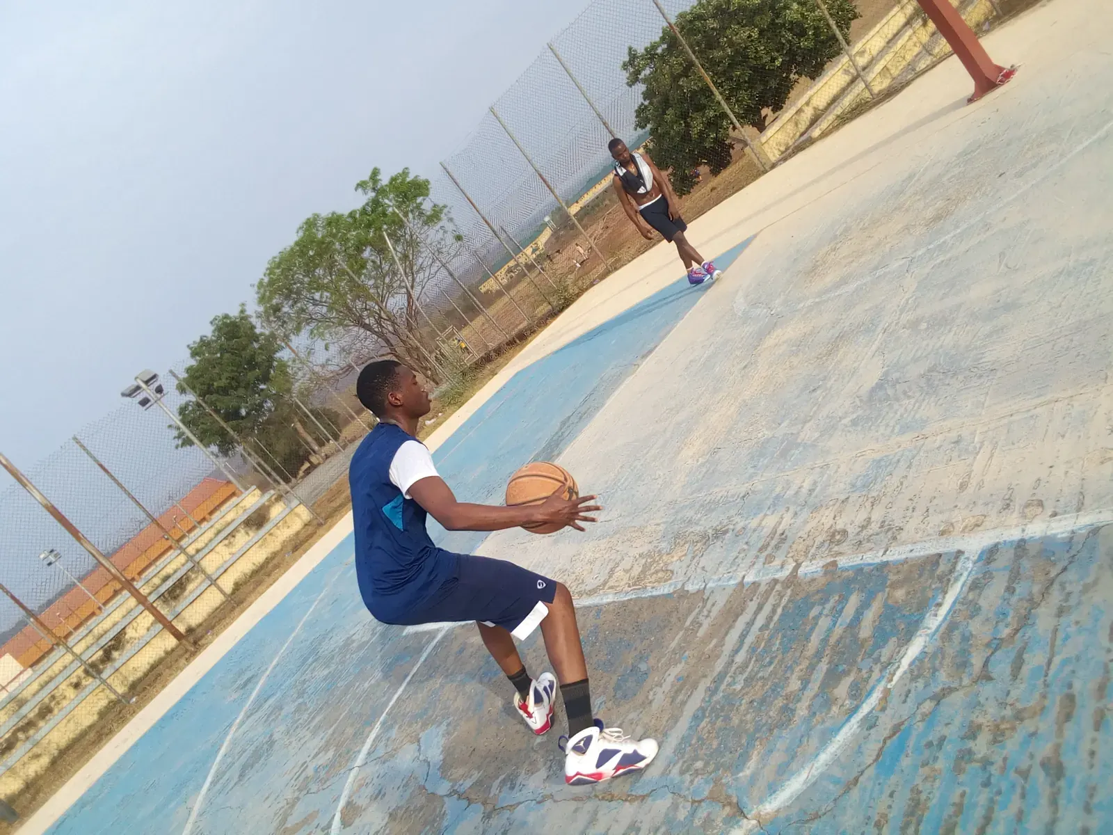 Basketball player in action on the court with digital analytics graphics superimposed.