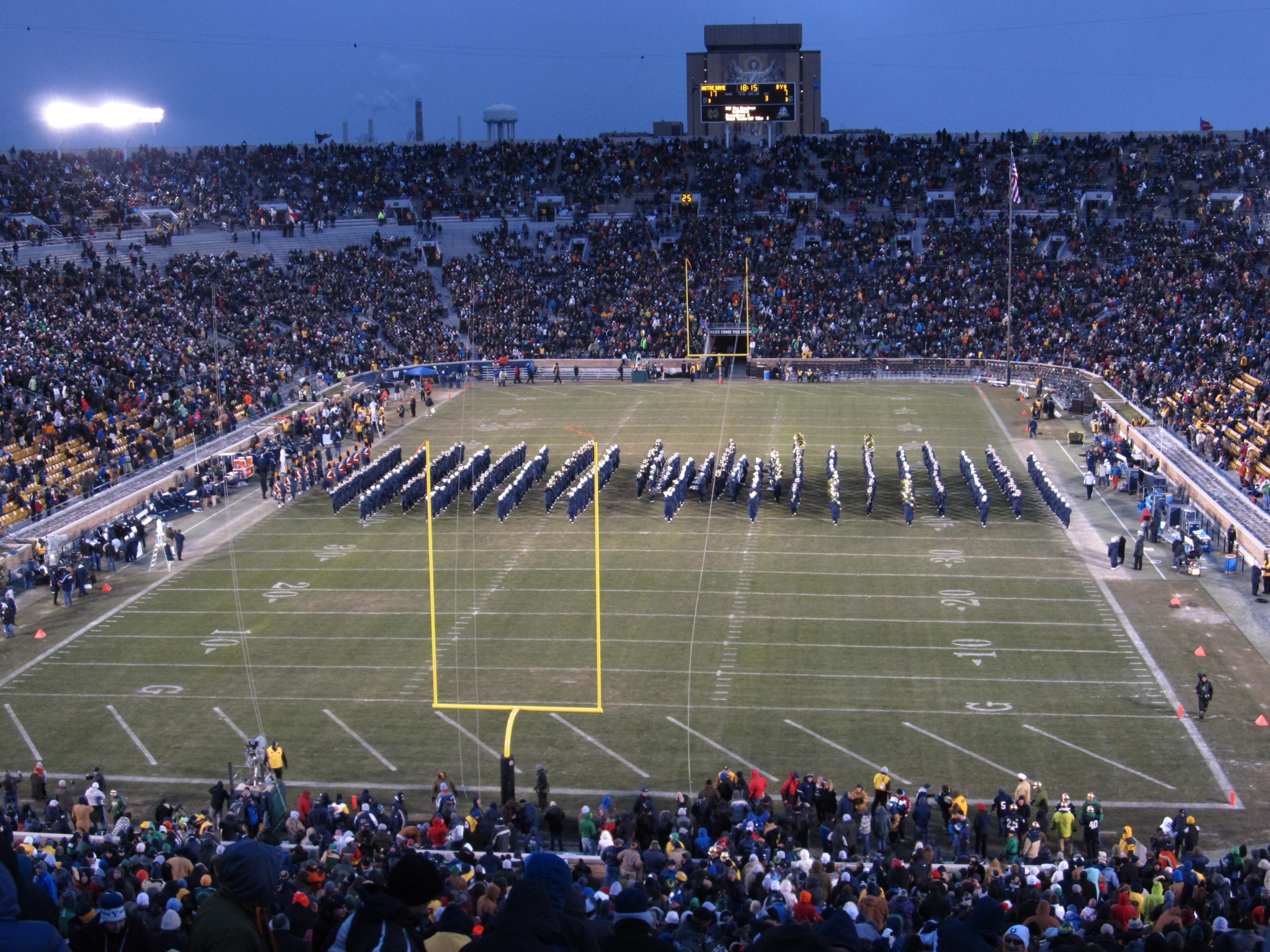 A group of Notre Dame Fighting Irish football players in uniform on the field.