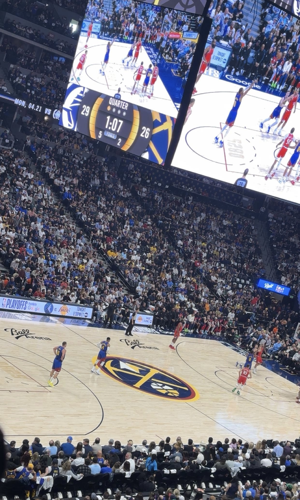 A basketball player on the court during an NBA game, with a focus on the intensity of the playoff race.