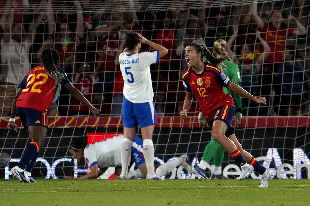 England and Spain women's national football teams in action during a World Cup qualifying match.