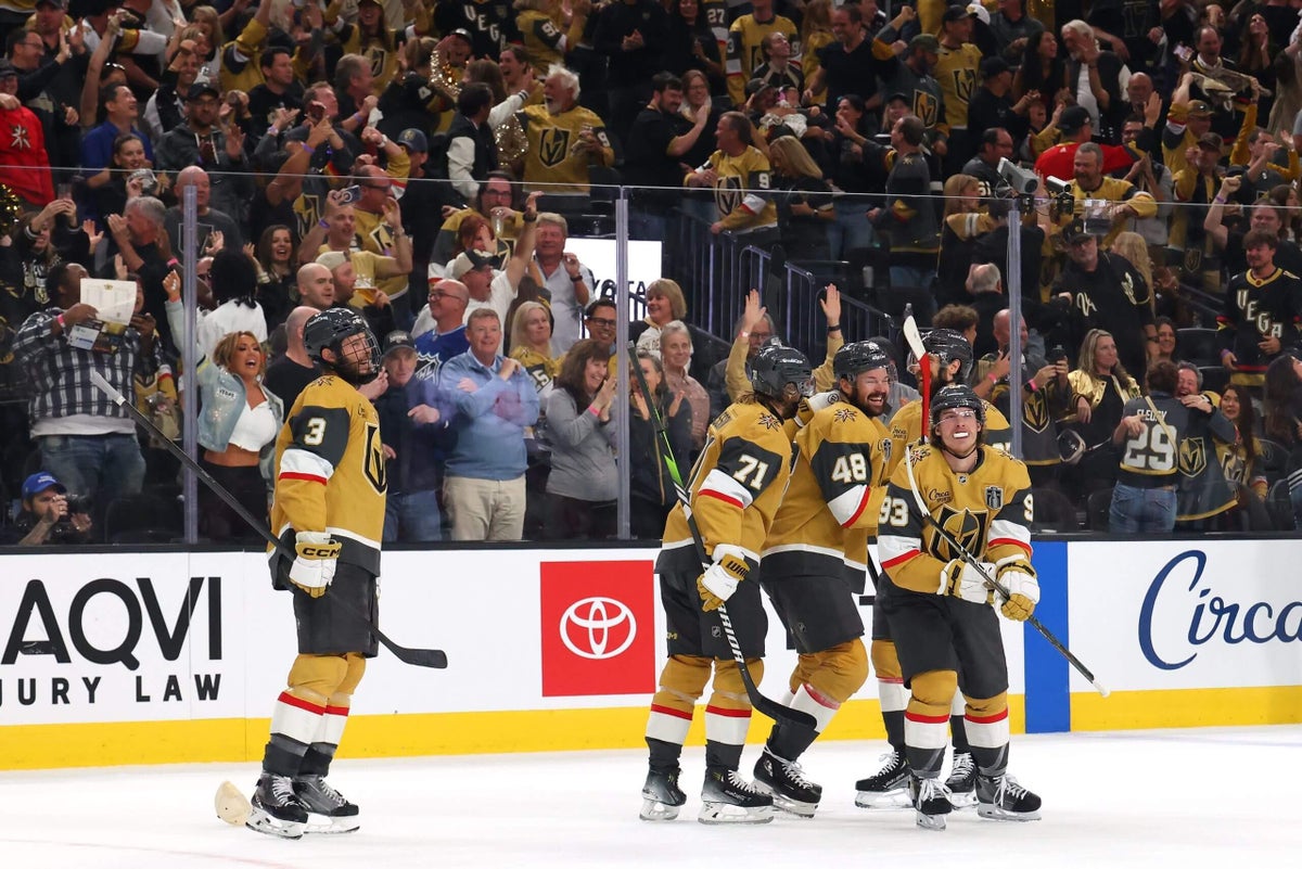 Players from the Vegas Golden Knights and Carolina Hurricanes compete for the puck during Game 3 of the Stanley Cup Final.