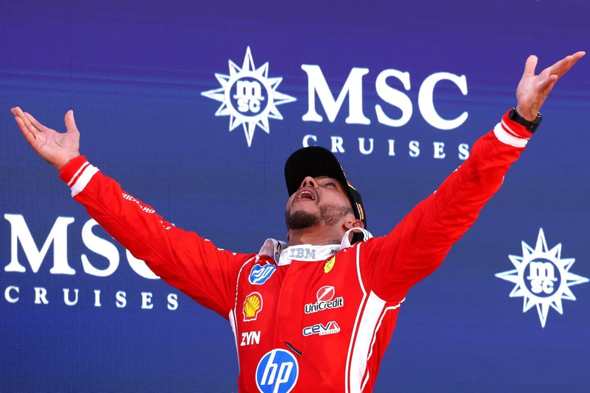 Lewis Hamilton celebrating his first Ferrari win on the podium at the Barcelona Grand Prix.
