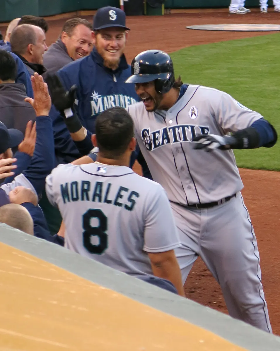 Athletics player rounds the bases after hitting a home run.