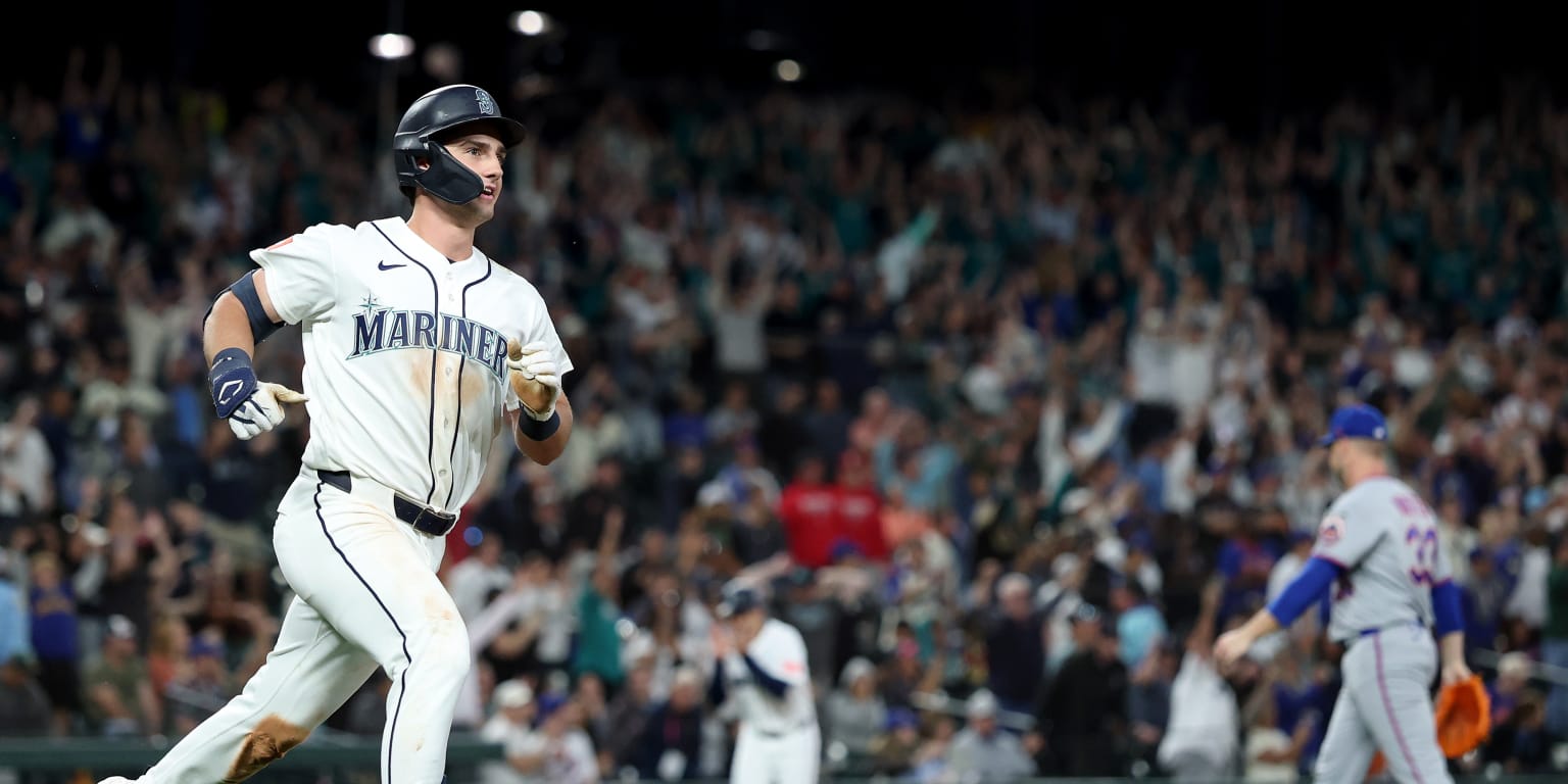 Seattle Mariners players celebrating on the field after a walk-off victory.