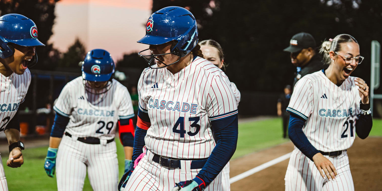 Athletes Unlimited Softball League players competing on the field.