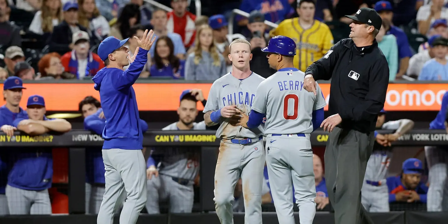 Chicago Cubs manager Craig Counsell in uniform, gesturing during a baseball game.