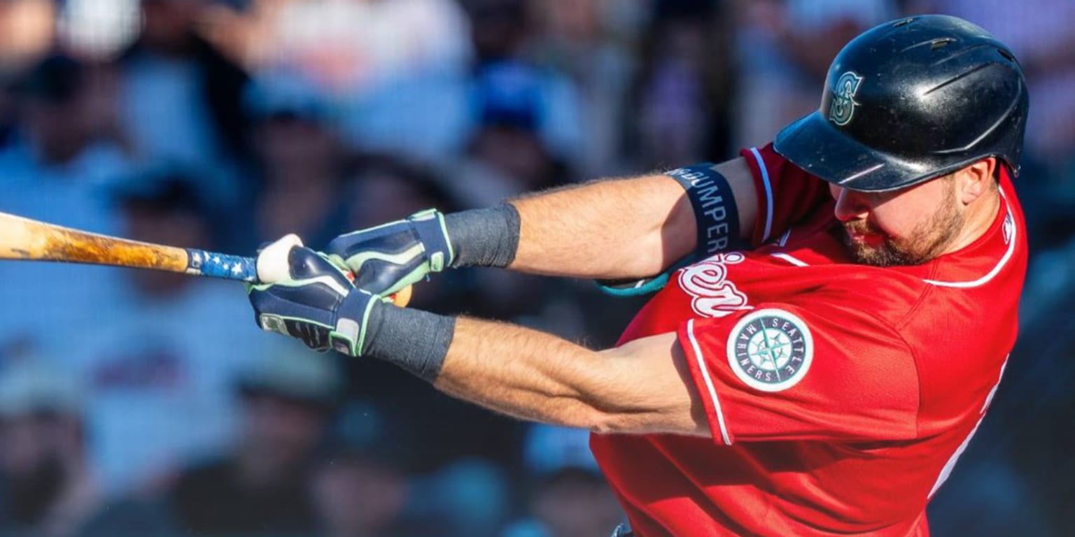 Cal Raleigh swings a baseball bat during a game.