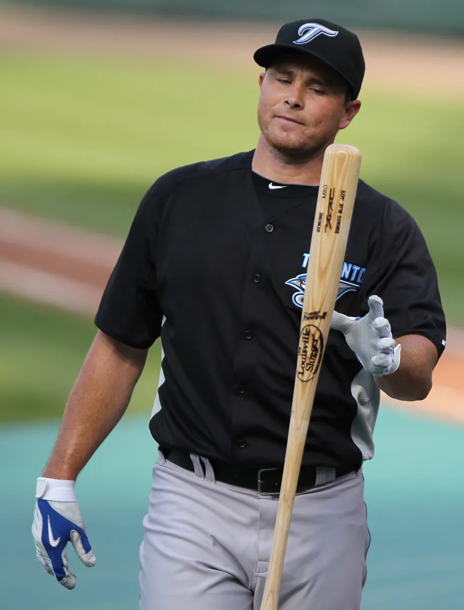 Toronto Blue Jays player swinging a baseball bat during a game.