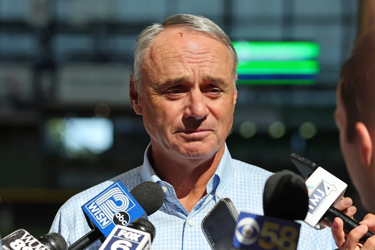 Major League Baseball owners and players union representatives in a meeting discussing salary cap and revenue split proposals