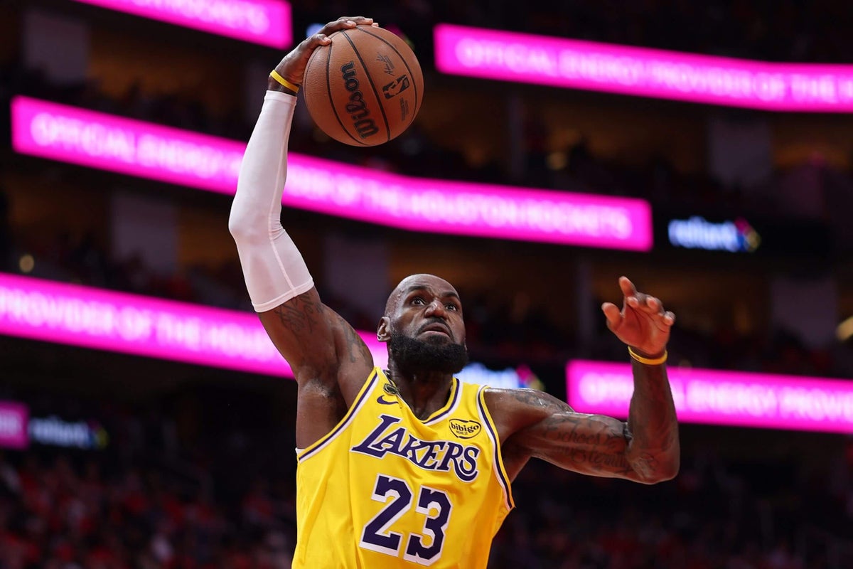 LeBron James wearing a Philadelphia 76ers jersey at a team introduction event on July 25, 2026
