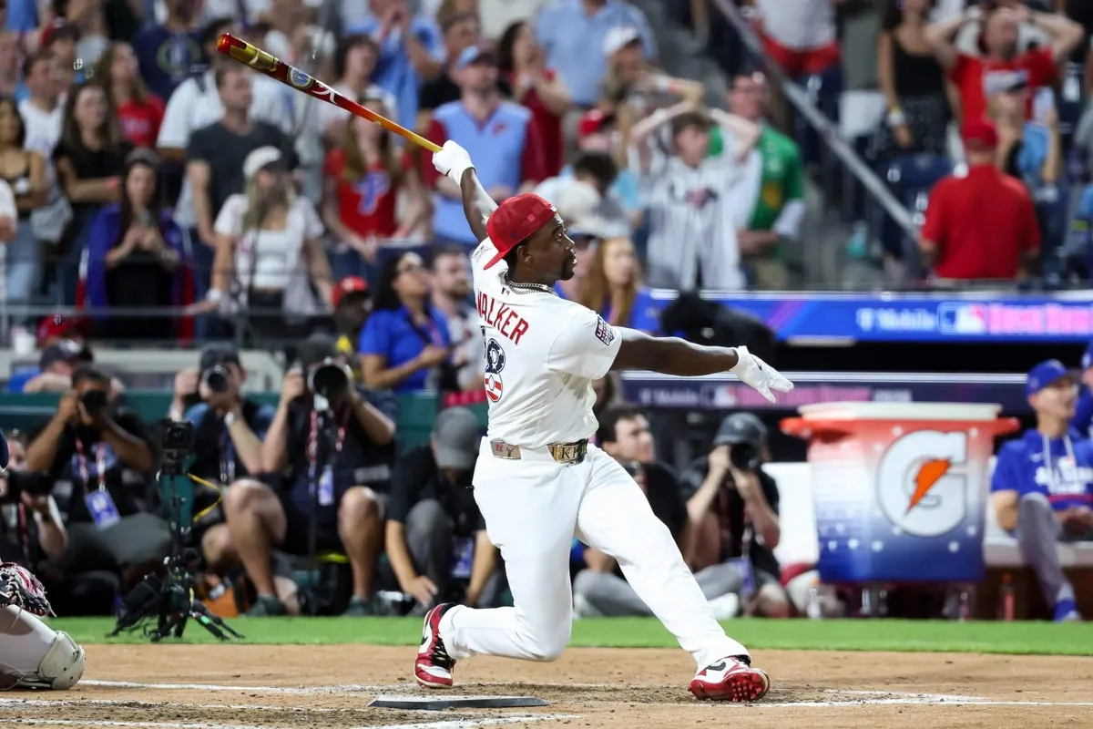 Jordan Walker celebrates his Home Run Derby victory as Kyle Schwarber looks on.