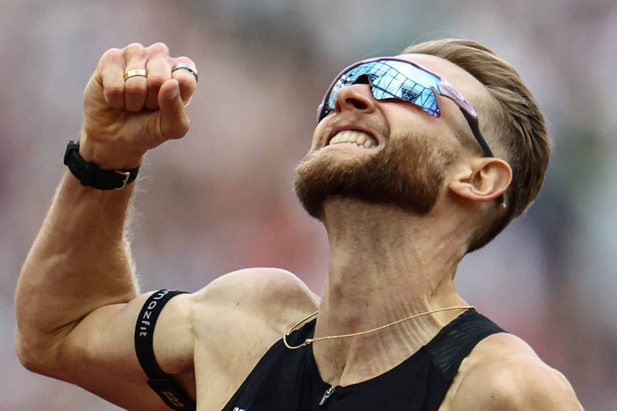 Josh Kerr crosses the finish line to set a new mile world record.