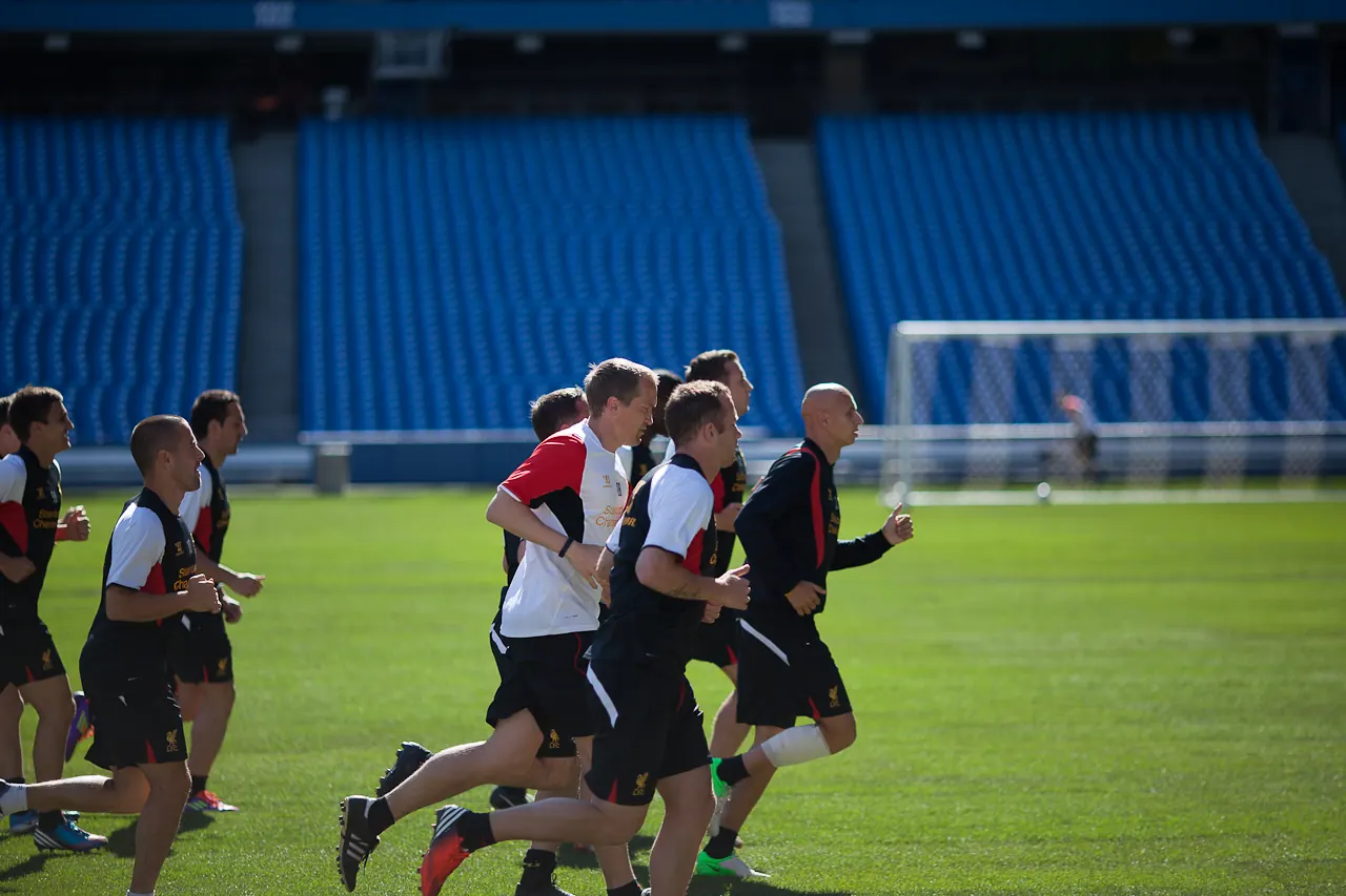 Liverpool FC players and coaching staff on a training pitch.