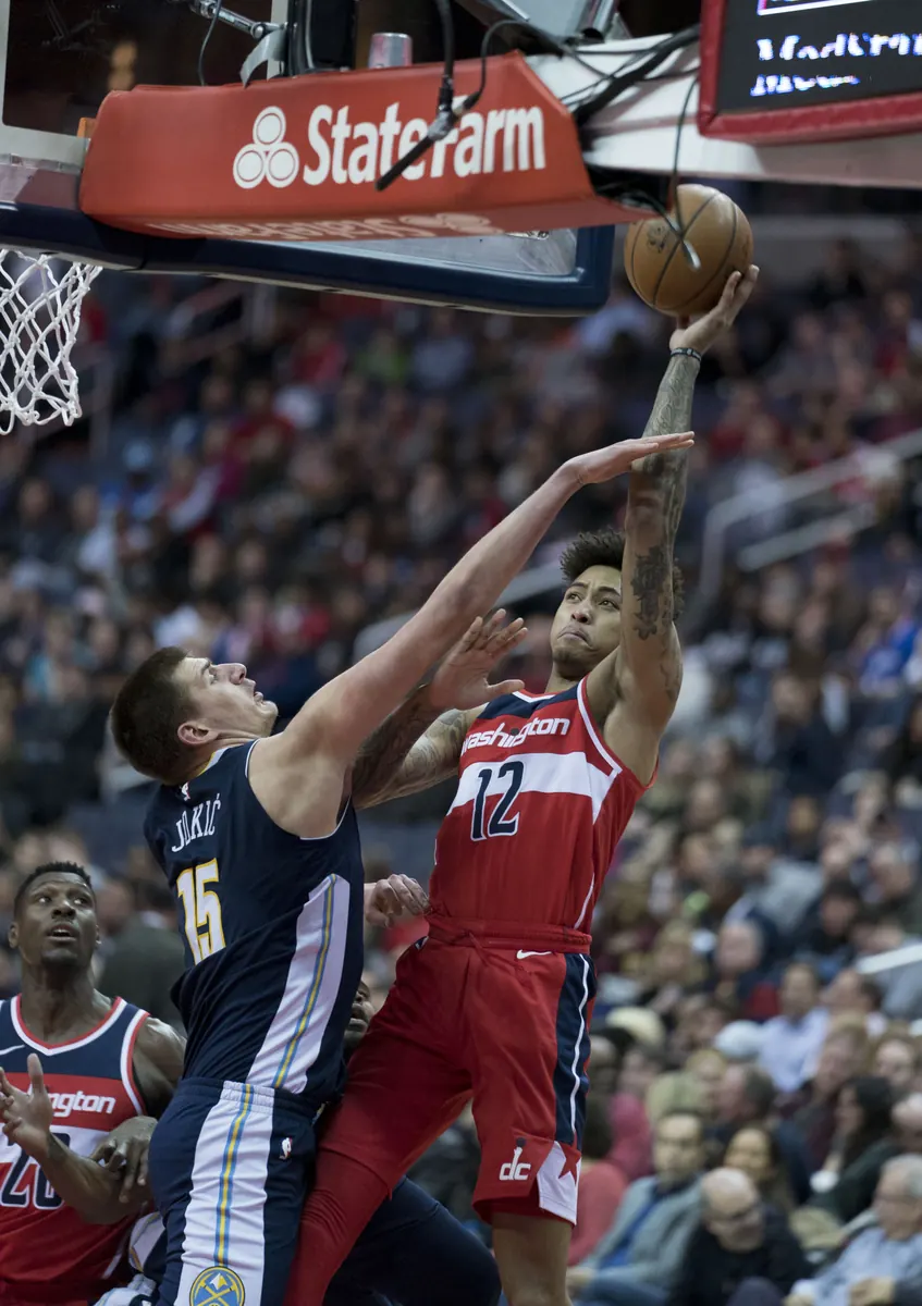 Nikola Jokic of the Denver Nuggets dribbles the ball during an NBA game.