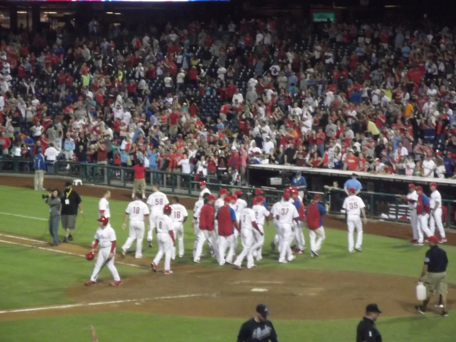 Philadelphia Phillies player rounds the bases after hitting a home run.