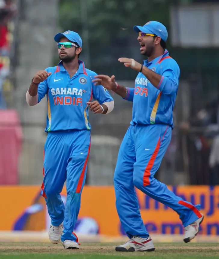 Indian cricket players in team uniforms on a sports field