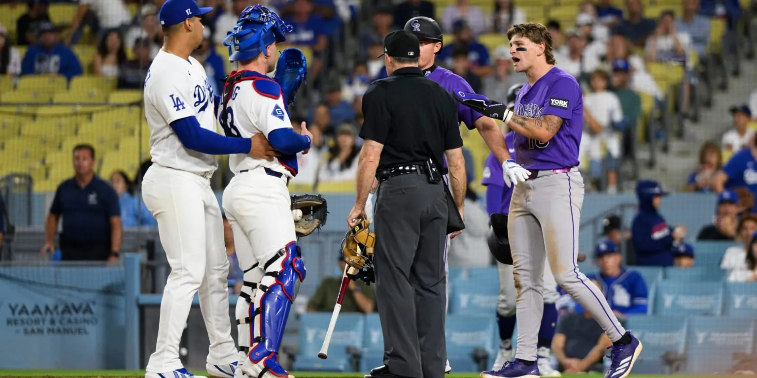 Los Angeles Dodgers catcher Dalton Rushing and Colorado Rockies runner Cole Carrigg make contact near home plate.