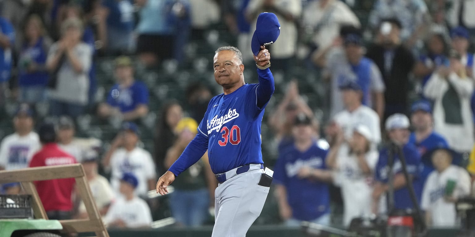 Los Angeles Dodgers manager Dave Roberts celebrating on the dugout.