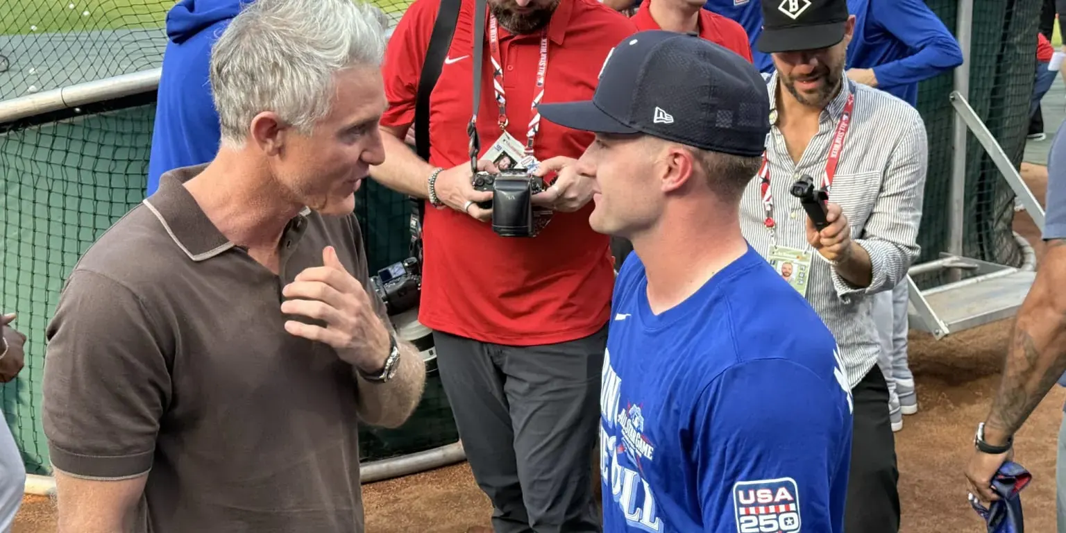 Detroit Tigers player Kevin McGonigle smiles as he stands near Chase Utley during batting practice at the MLB All-Star Game.
