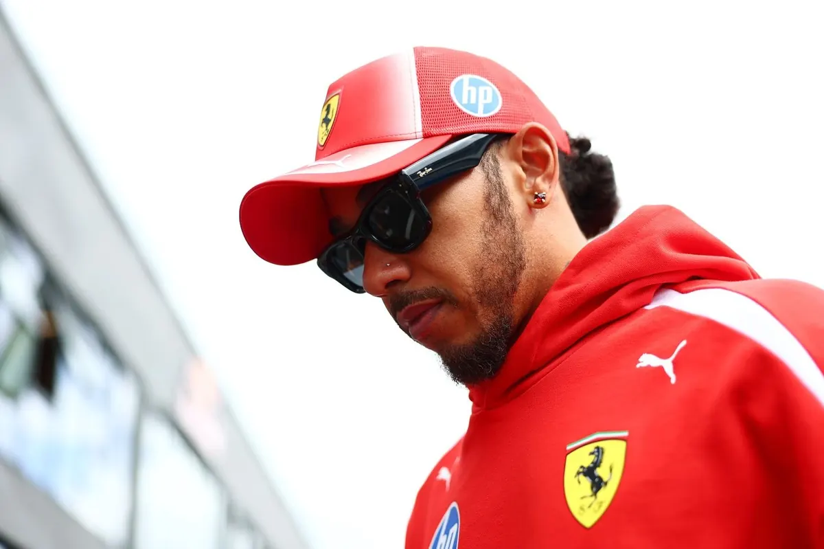 Lewis Hamilton in Ferrari team kit at the Hungaroring, looking reflective after qualifying for the Hungarian Grand Prix