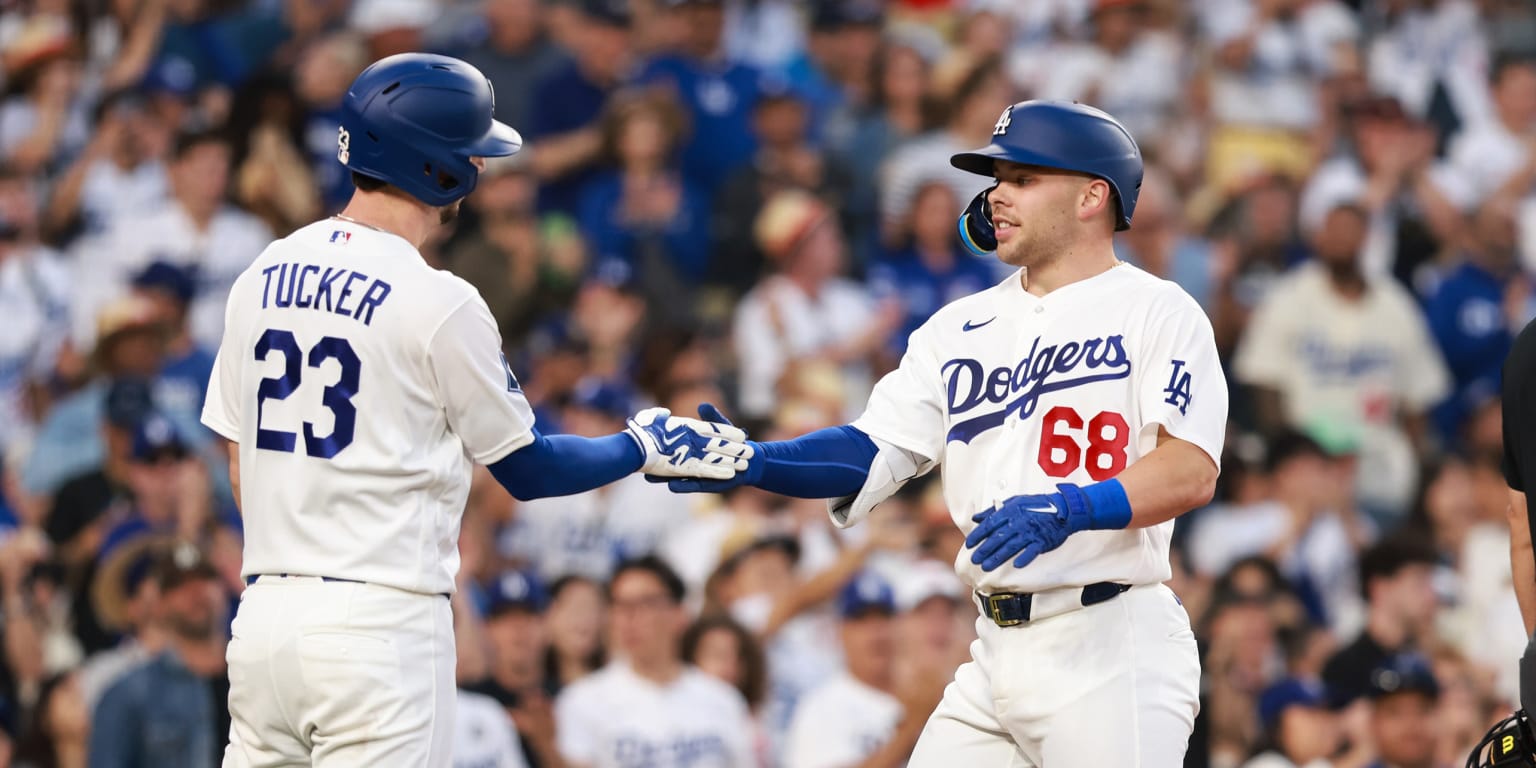 Los Angeles Dodgers players celebrating a comeback victory on the field.