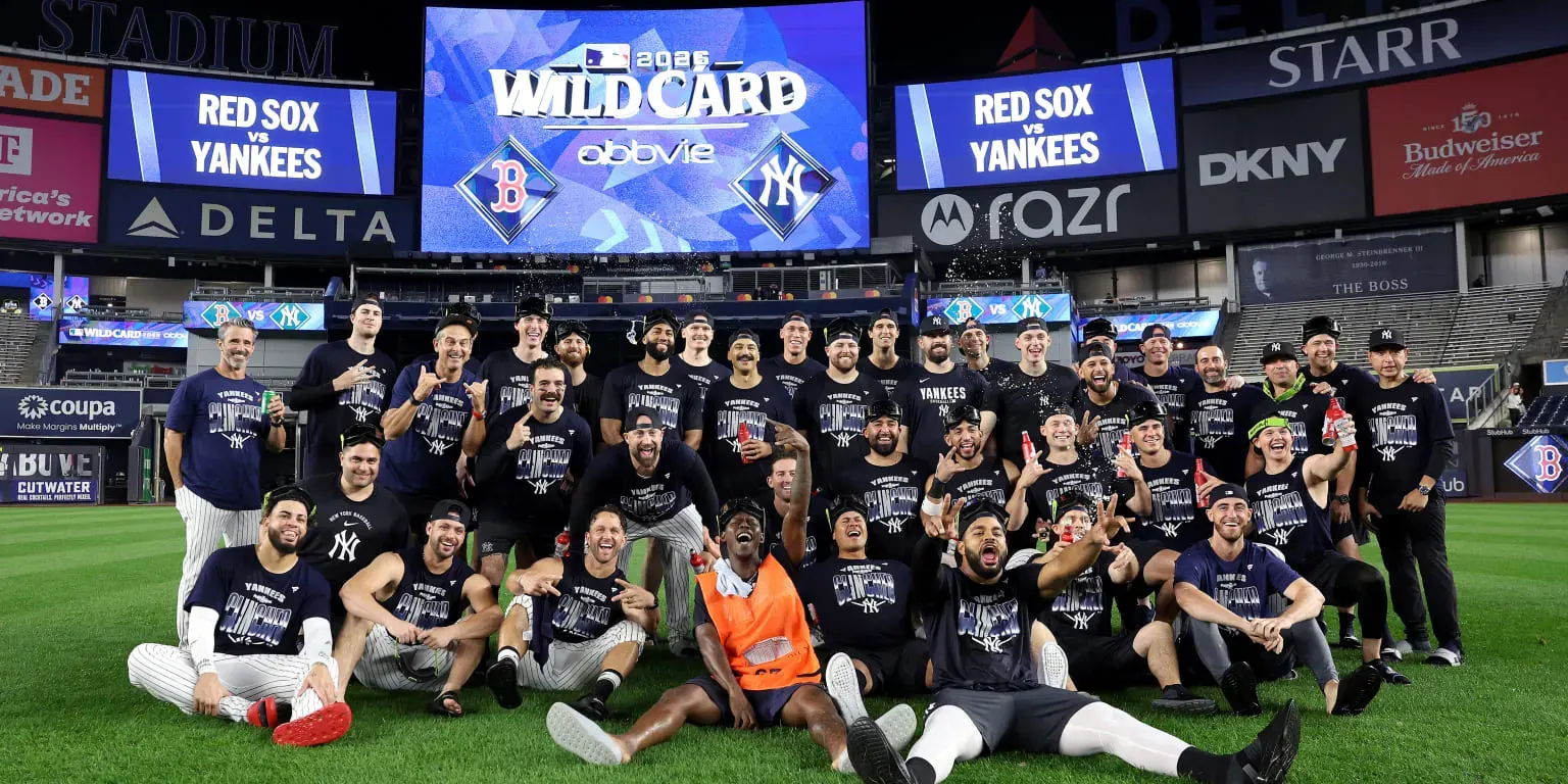 Yankees players celebrate their AL Wild Card Series sweep of the Red Sox at Yankee Stadium